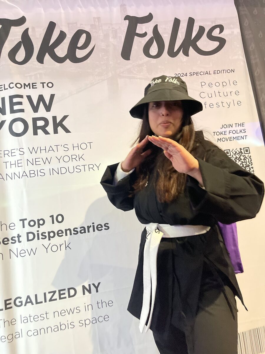 A guest posing on the Toke Folks magazine cover backdrop