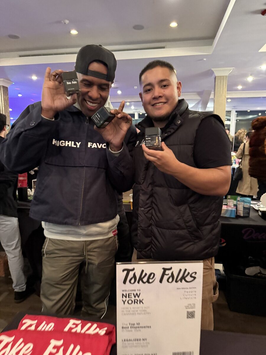 Two guests holding Toke Folks product at an industry event