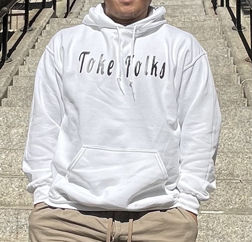 Close-up of the white Toke Folks hoodie