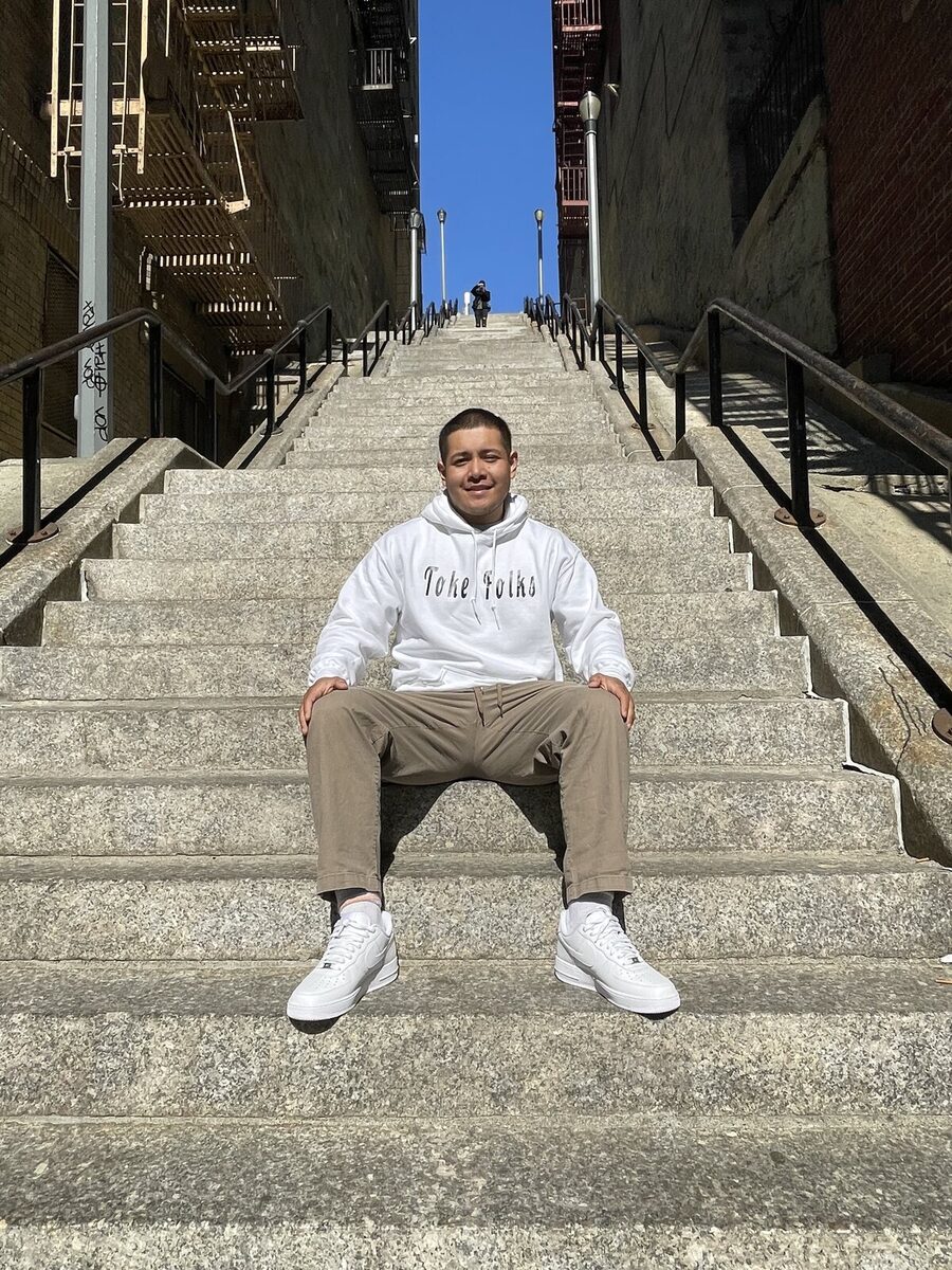 A Toke Folks hoodie on a New York stairway