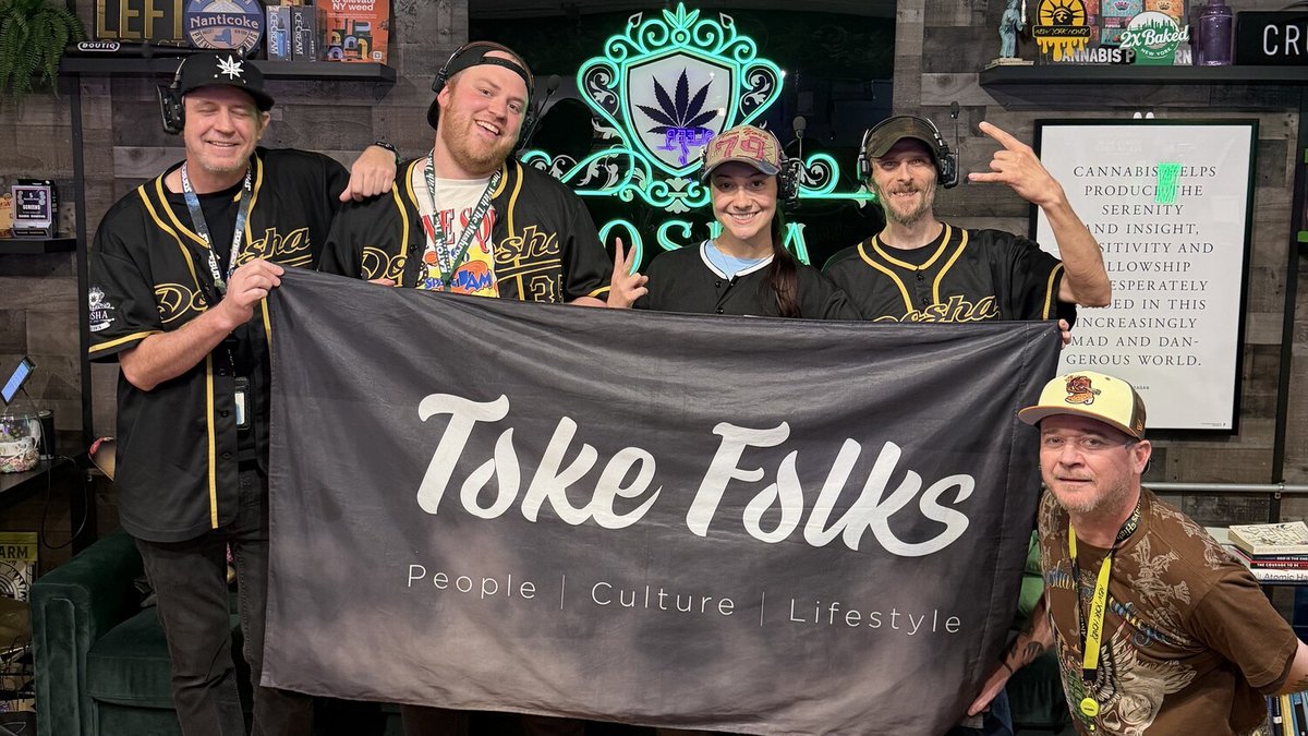The Toke Folks crew on a New York block holding the Toke Folks flag